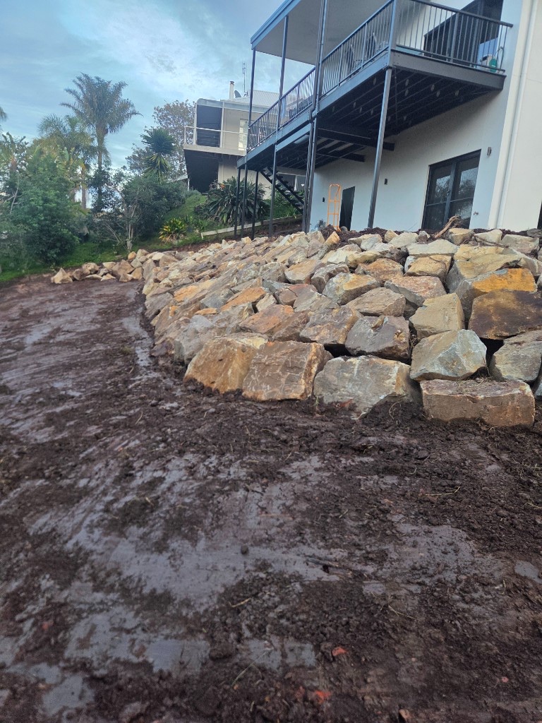 Natural stone retaining wall below a modern house