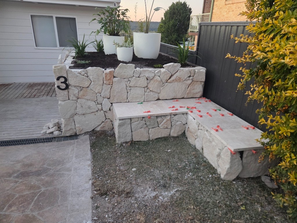 Stone retaining wall and bench landscaping