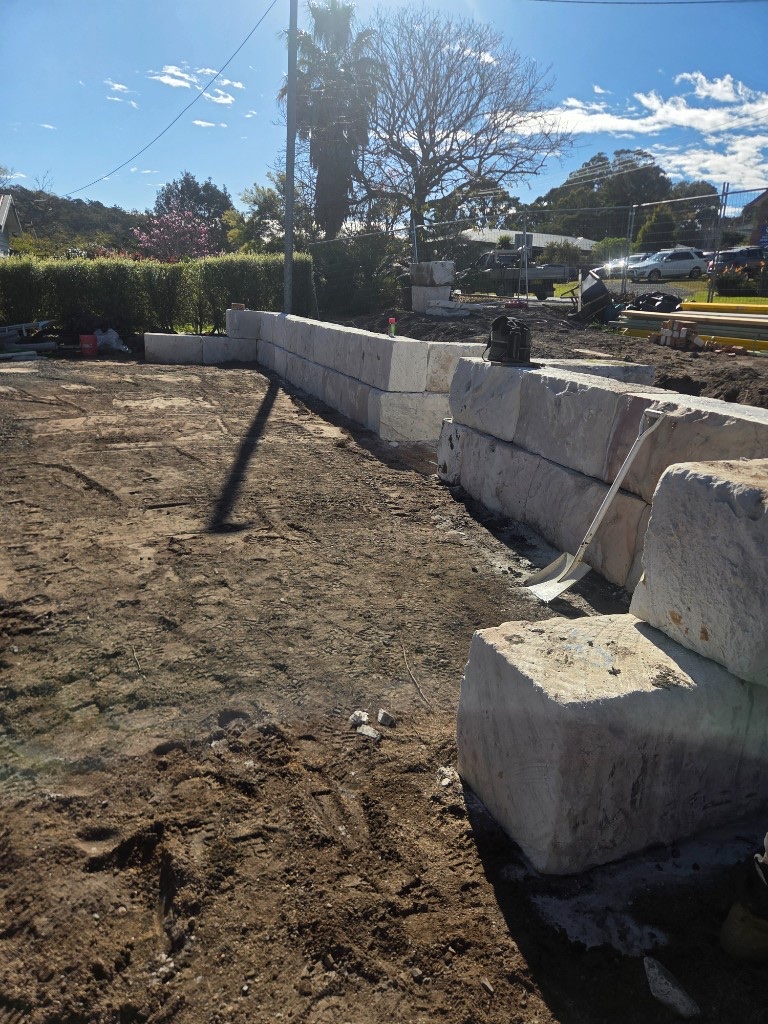 Sandstone block retaining wall under construction