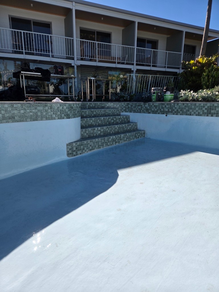 Refinished swimming pool interior with mosaic steps