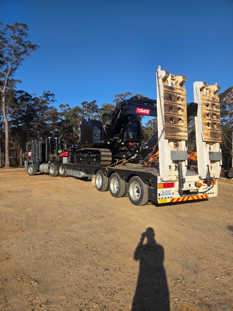 Excavator loaded on a low loader trailer